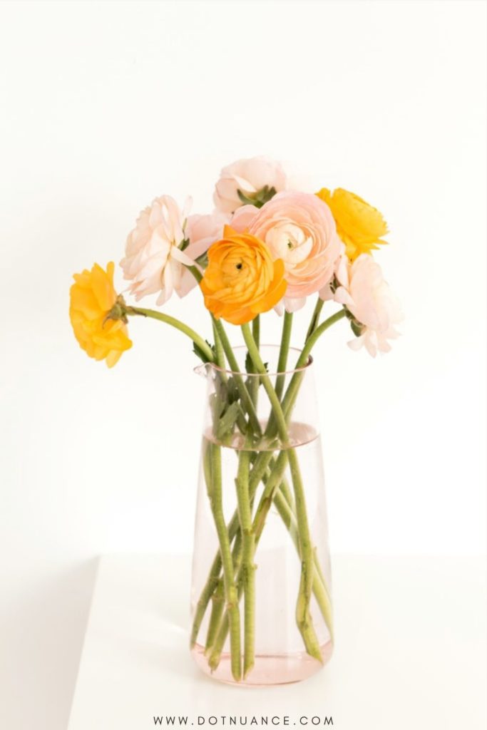 peonies in glass vase